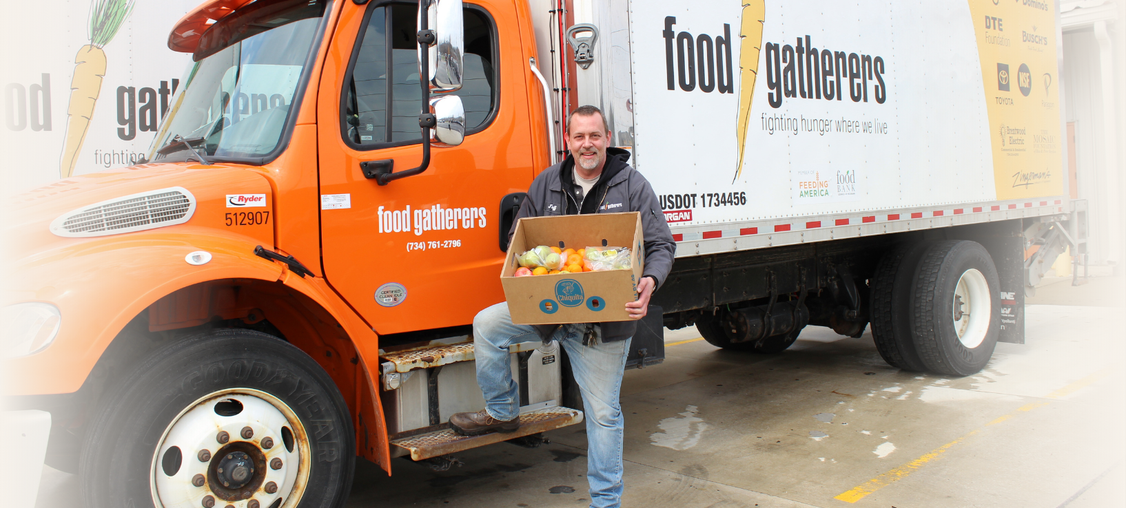 Food Gatherers volunteers help unload a truck